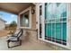Inviting front porch featuring comfortable seating and a stylish screen door at 2805 Masters Ln, Castle Rock, CO 80104