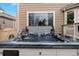 Inviting hot tub on the back patio for relaxation, with a nearby window at 2805 Masters Ln, Castle Rock, CO 80104