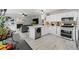 Open concept kitchen with stainless appliances adjacent to living room with fireplace and built-in shelving at 2805 Masters Ln, Castle Rock, CO 80104
