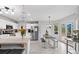 Open-concept kitchen and dining area with stainless steel appliances, island, and access to outdoor deck at 2805 Masters Ln, Castle Rock, CO 80104