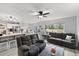 Open floor plan living room with neutral decor, large windows, and view of the kitchen and dining area at 2805 Masters Ln, Castle Rock, CO 80104