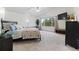 The main bedroom with abundant natural light features carpet floors, a ceiling fan and a large ensuite bath at 2805 Masters Ln, Castle Rock, CO 80104