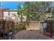 Private backyard area featuring gravel cover, wood fence, with mature trees and outdoor seating at 12043 E Ford Cir, Aurora, CO 80012