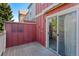 Balcony view with brown fencing, view of nearby buildings through the trees at 12043 E Ford Cir, Aurora, CO 80012