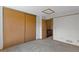 Bedroom featuring ample closet space and doorway to hallway at 12043 E Ford Cir, Aurora, CO 80012