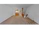 Open floor plan, living room flows into kitchen, with neutral carpet and staircase at 12043 E Ford Cir, Aurora, CO 80012