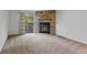 Living room boasts a stone fireplace with glass doors and a sliding door to a deck at 12043 E Ford Cir, Aurora, CO 80012