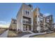 Modern three-story townhome with attached two-car garage and balcony at 15878 E Broncos Pl, Englewood, CO 80112