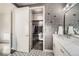Bathroom with dual vanity, walk-in closet, modern fixtures, and patterned tile floors at 15878 E Broncos Pl, Englewood, CO 80112