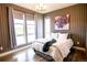 Serene bedroom featuring a calming color scheme, modern lighting, and large windows at 15878 E Broncos Pl, Englewood, CO 80112