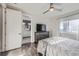 Bedroom with hardwood floors, ensuite bath, and natural light at 15878 E Broncos Pl, Englewood, CO 80112