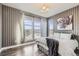 Inviting bedroom featuring stylish accent wall, hardwood floors and large window at 15878 E Broncos Pl, Englewood, CO 80112