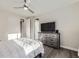 Bedroom featuring a ceiling fan, a dresser with a television, and convenient access to the closet at 15878 E Broncos Pl, Englewood, CO 80112