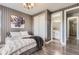 Bedroom features stylish striped walls, wood floors, and an ensuite bathroom at 15878 E Broncos Pl, Englewood, CO 80112