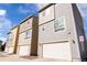 View of modern townhomes featuring attached garages, neutral siding, and clean architectural lines at 15878 E Broncos Pl, Englewood, CO 80112