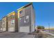 Modern townhome with two-car garage featuring a neutral gray exterior at 15878 E Broncos Pl, Englewood, CO 80112