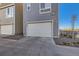 Attached two-car garage with a paved driveway and low maintenance landscaping at 15878 E Broncos Pl, Englewood, CO 80112