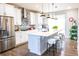 Modern kitchen featuring stainless steel appliances, quartz countertops, and a sleek island with seating at 15878 E Broncos Pl, Englewood, CO 80112