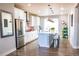 Stylish kitchen boasts stainless steel appliances, a center island, and ample cabinet space at 15878 E Broncos Pl, Englewood, CO 80112