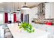 Open-concept kitchen with a spacious island and modern finishes, seamlessly connects to the living area at 15878 E Broncos Pl, Englewood, CO 80112
