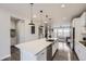 Spacious kitchen with a large island, stainless steel appliances, and open layout to living spaces at 15878 E Broncos Pl, Englewood, CO 80112