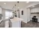 Bright kitchen features pendant lighting, a large island, stainless steel sink, and adjacent office nook at 15878 E Broncos Pl, Englewood, CO 80112