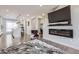 Spacious living room with hardwood floors, adjacent office and modern fireplace at 15878 E Broncos Pl, Englewood, CO 80112