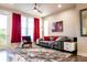 Comfortable living room featuring a plush rug, contemporary furniture, and bright, natural light at 15878 E Broncos Pl, Englewood, CO 80112