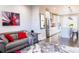 Open concept living room view showcasing the modern kitchen and hardwood floors throughout at 15878 E Broncos Pl, Englewood, CO 80112