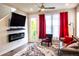 Cozy living room featuring plush seating, an electric fireplace, and access to a balcony at 15878 E Broncos Pl, Englewood, CO 80112