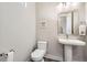 Compact powder room featuring modern fixtures and stylish decor elements at 15878 E Broncos Pl, Englewood, CO 80112
