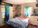 Colorful bedroom with a large bed, bright curtains, and two windows providing natural light at 3953 Vrain St, Denver, CO 80212