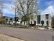 Contemporary townhomes with black and white exteriors line a tree-lined street with well-maintained landscaping at 3953 Vrain St, Denver, CO 80212