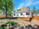 Spacious backyard featuring a large wooden deck, mature tree, and lush lawn at 8694 E Eastman Ave, Denver, CO 80231