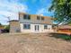 Backyard view showcases an elevated wood deck, sliding glass door, and fenced yard at 8694 E Eastman Ave, Denver, CO 80231
