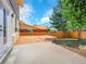 Backyard features a wood deck, fenced yard, patio, and mature trees at 8694 E Eastman Ave, Denver, CO 80231