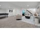 Finished basement boasts a spacious layout, stairs to upper level, and carpeted flooring at 8694 E Eastman Ave, Denver, CO 80231