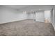 Unfinished basement with neutral walls, carpet, and access to the bathroom at 8694 E Eastman Ave, Denver, CO 80231