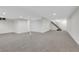 Finished basement with neutral walls, gray carpet, and stairway at 8694 E Eastman Ave, Denver, CO 80231