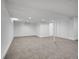 Unfinished basement boasts neutral walls, carpet, and storage closet at 8694 E Eastman Ave, Denver, CO 80231