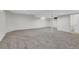 Finished basement with neutral walls, gray carpet, and natural light at 8694 E Eastman Ave, Denver, CO 80231