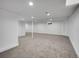 Unfinished basement features neutral walls and carpeted flooring at 8694 E Eastman Ave, Denver, CO 80231