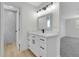 Modern bathroom featuring a vanity with sleek hardware, modern mirror, and a tiled walk in shower at 8694 E Eastman Ave, Denver, CO 80231