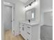 Bathroom with white vanity, black hardware, modern lighting, and shower at 8694 E Eastman Ave, Denver, CO 80231