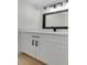 Bathroom vanity features a white quartz countertop and dark bronze accents at 8694 E Eastman Ave, Denver, CO 80231