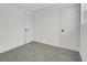 Carpeted bedroom featuring two doors and white trim at 8694 E Eastman Ave, Denver, CO 80231