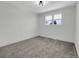 Bedroom with a window and plush carpet at 8694 E Eastman Ave, Denver, CO 80231