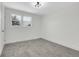 Bedroom featuring neutral walls, plush carpet, ample natural light, and updated lighting at 8694 E Eastman Ave, Denver, CO 80231