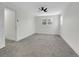 A bright, carpeted bedroom with a ceiling fan and window at 8694 E Eastman Ave, Denver, CO 80231