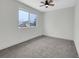 Bright bedroom features a ceiling fan and a window view of the outdoors at 8694 E Eastman Ave, Denver, CO 80231
